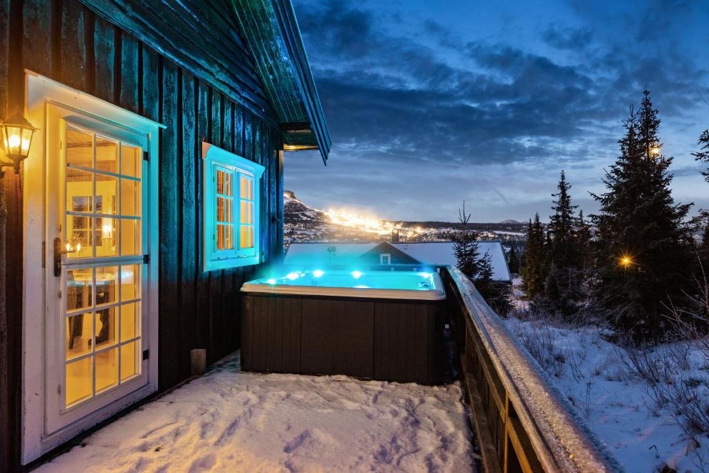 Private outdoor hot tub with mountain view at dusk